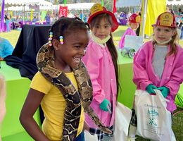 Girl particpates in health fair event and has snack around her neck