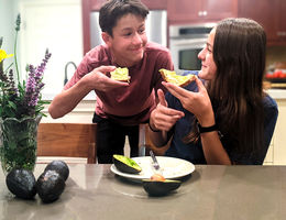 Teens eating avocados