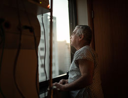 Senior patient looking out hospital window
