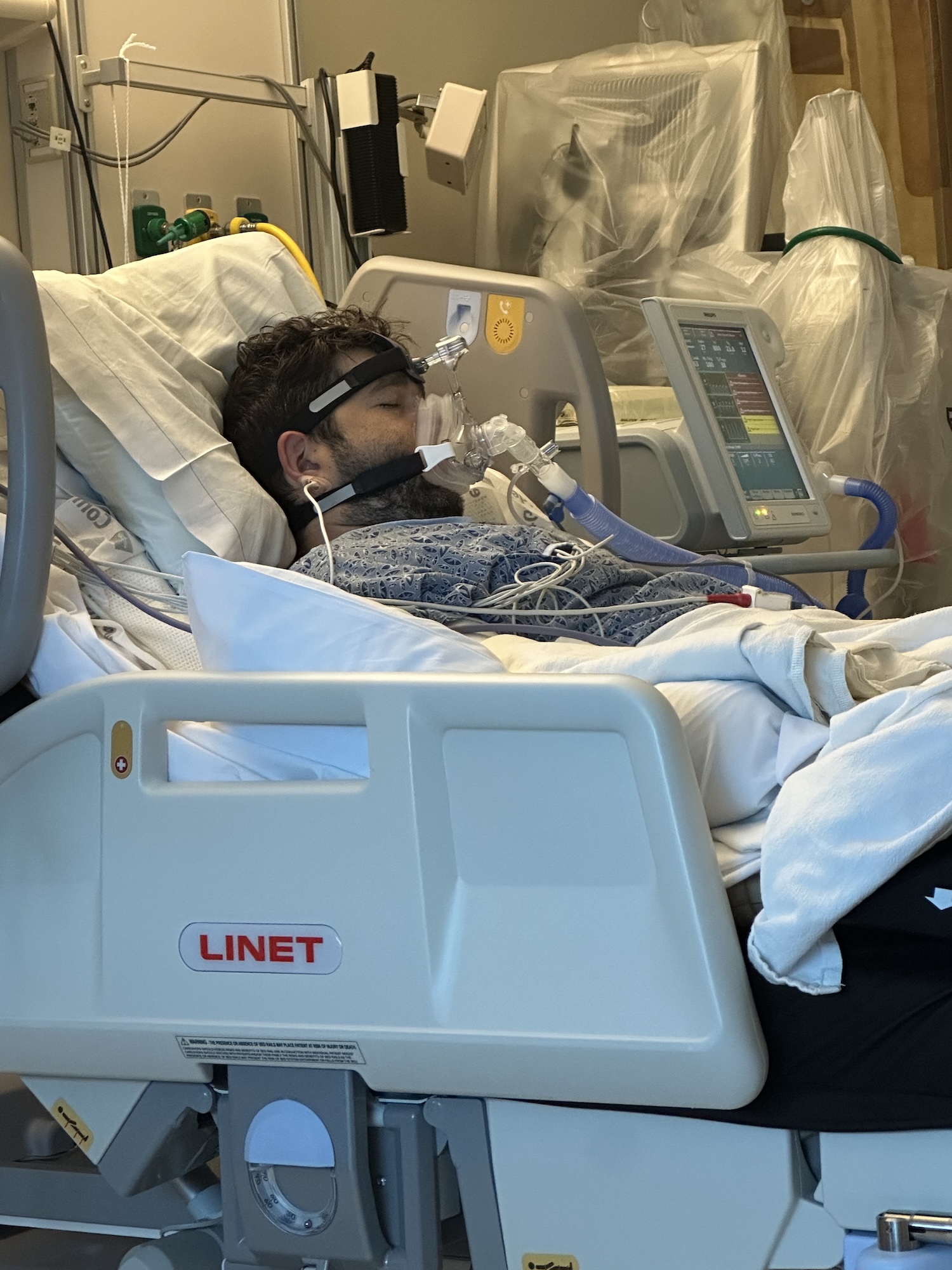 A young man in a hospital bed