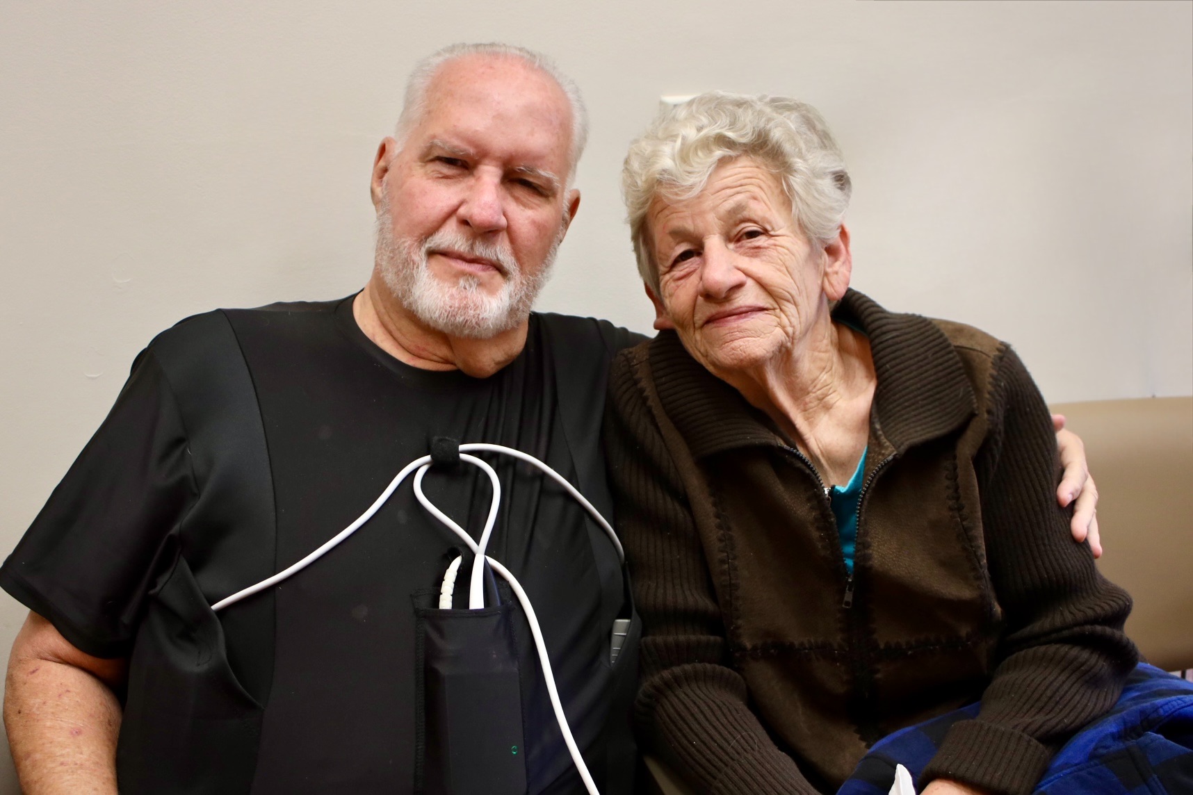 an older man and a woman pose together 