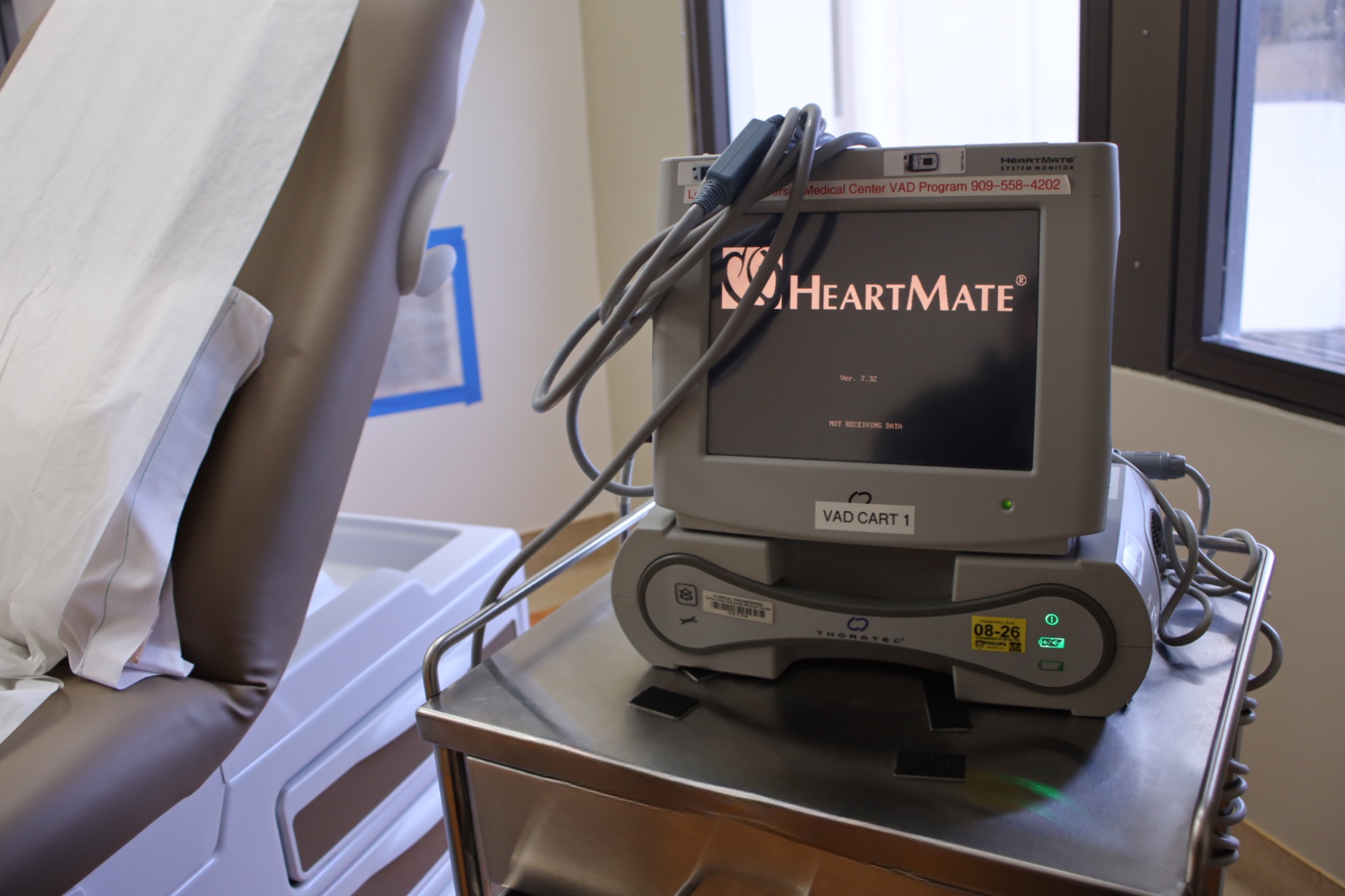 a medical device called heartmate is pictured next to a medical exam chair