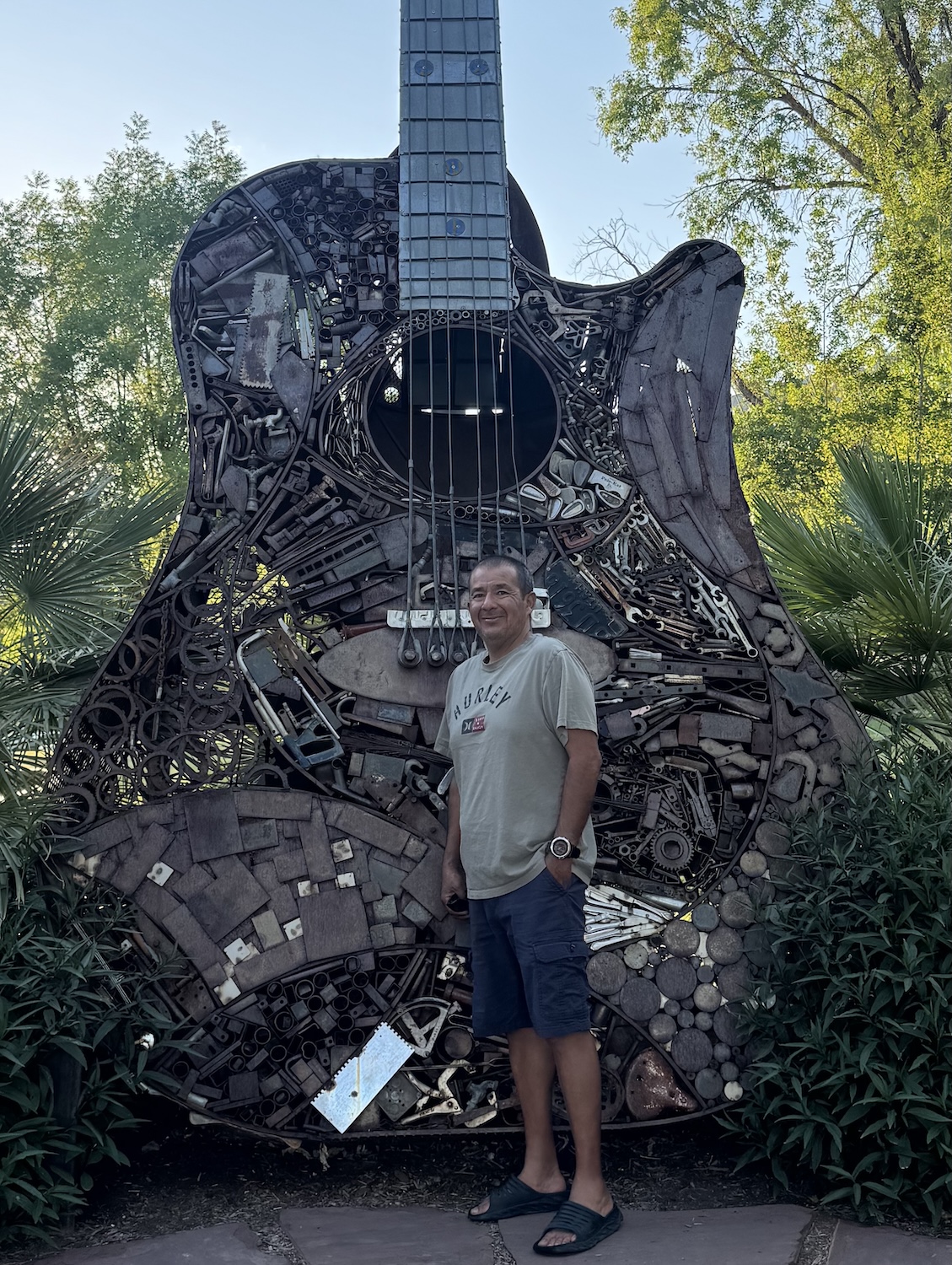 Gonzalez stands in front of a giant guitar sculpture 
