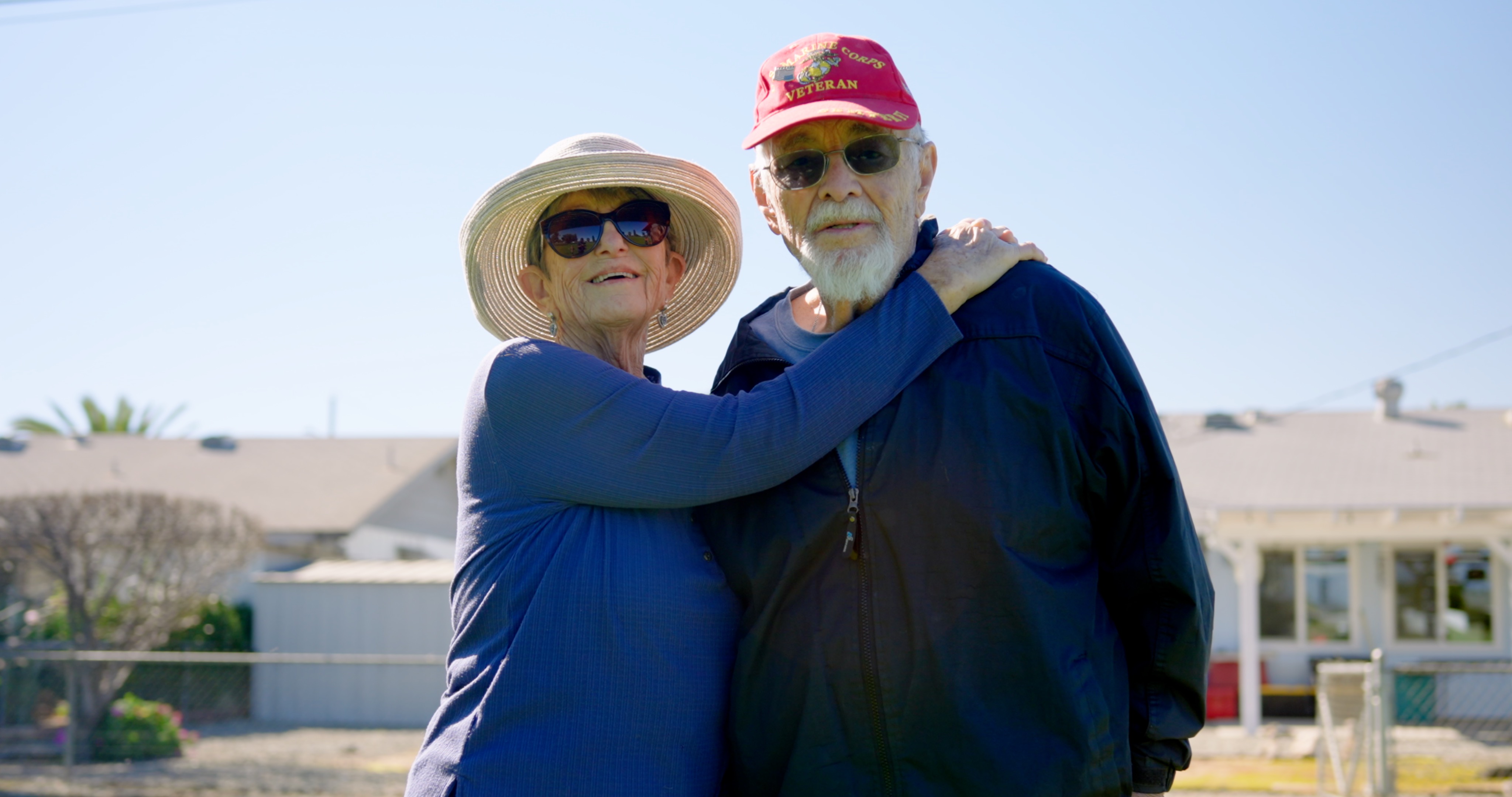 Woman with arms around her husband