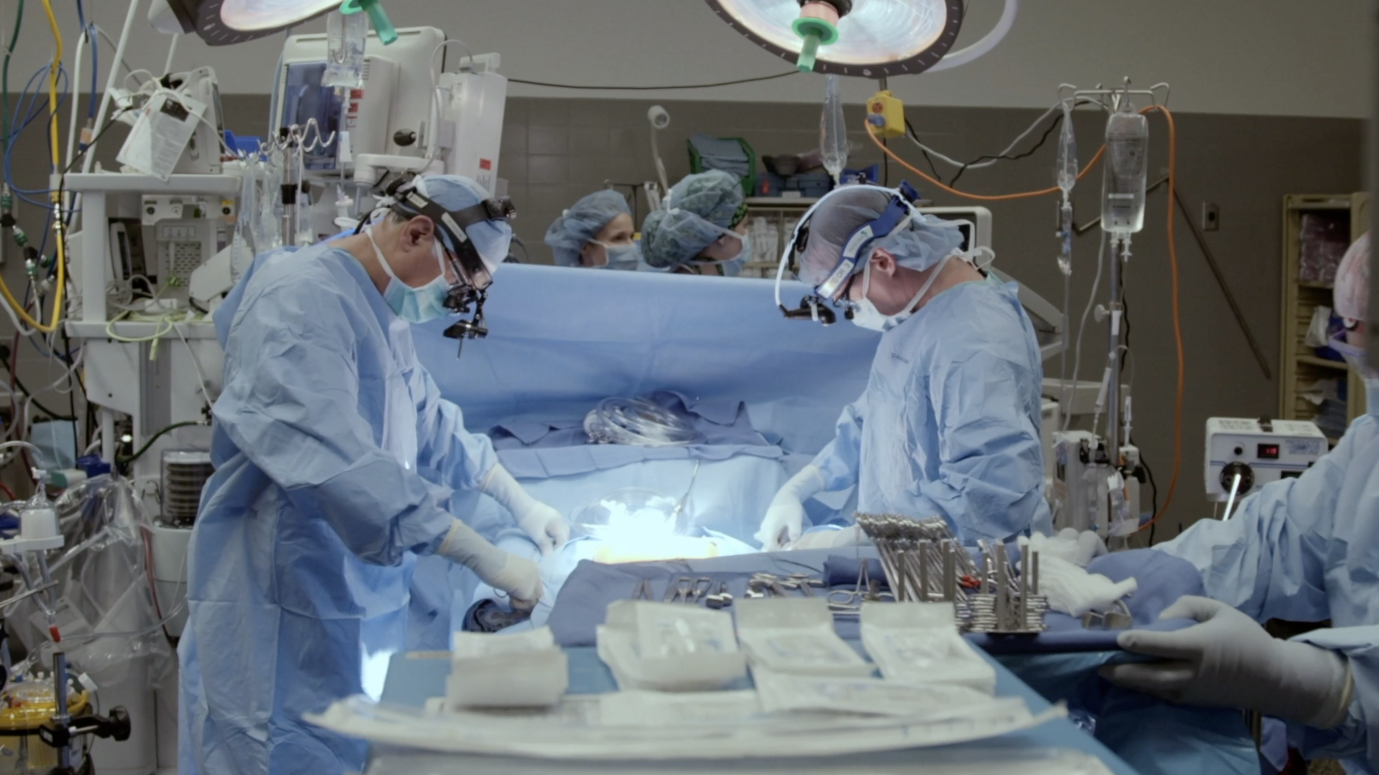 a group of medical doctors perform a surgery in an operating room