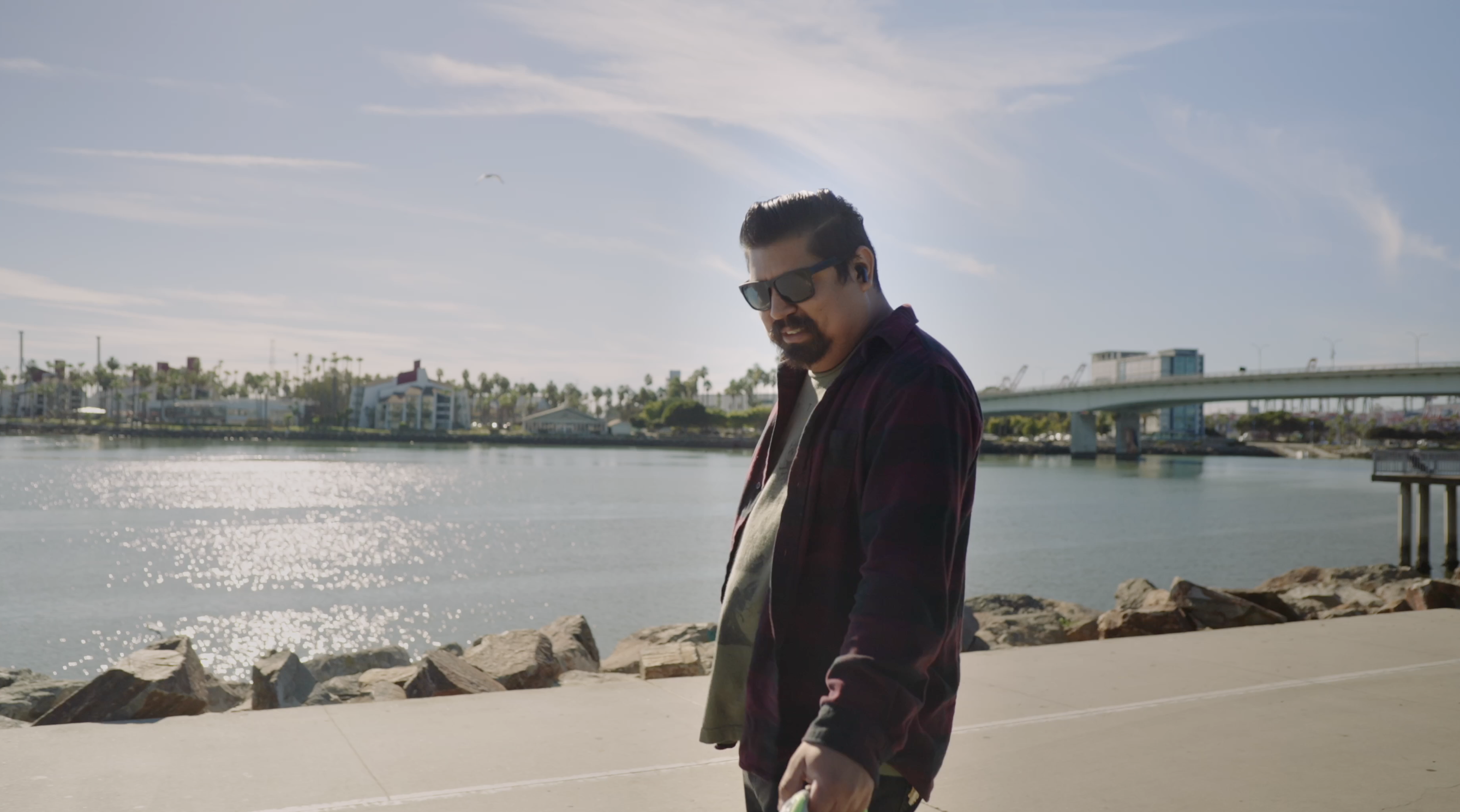 a man is walking in front a body of water