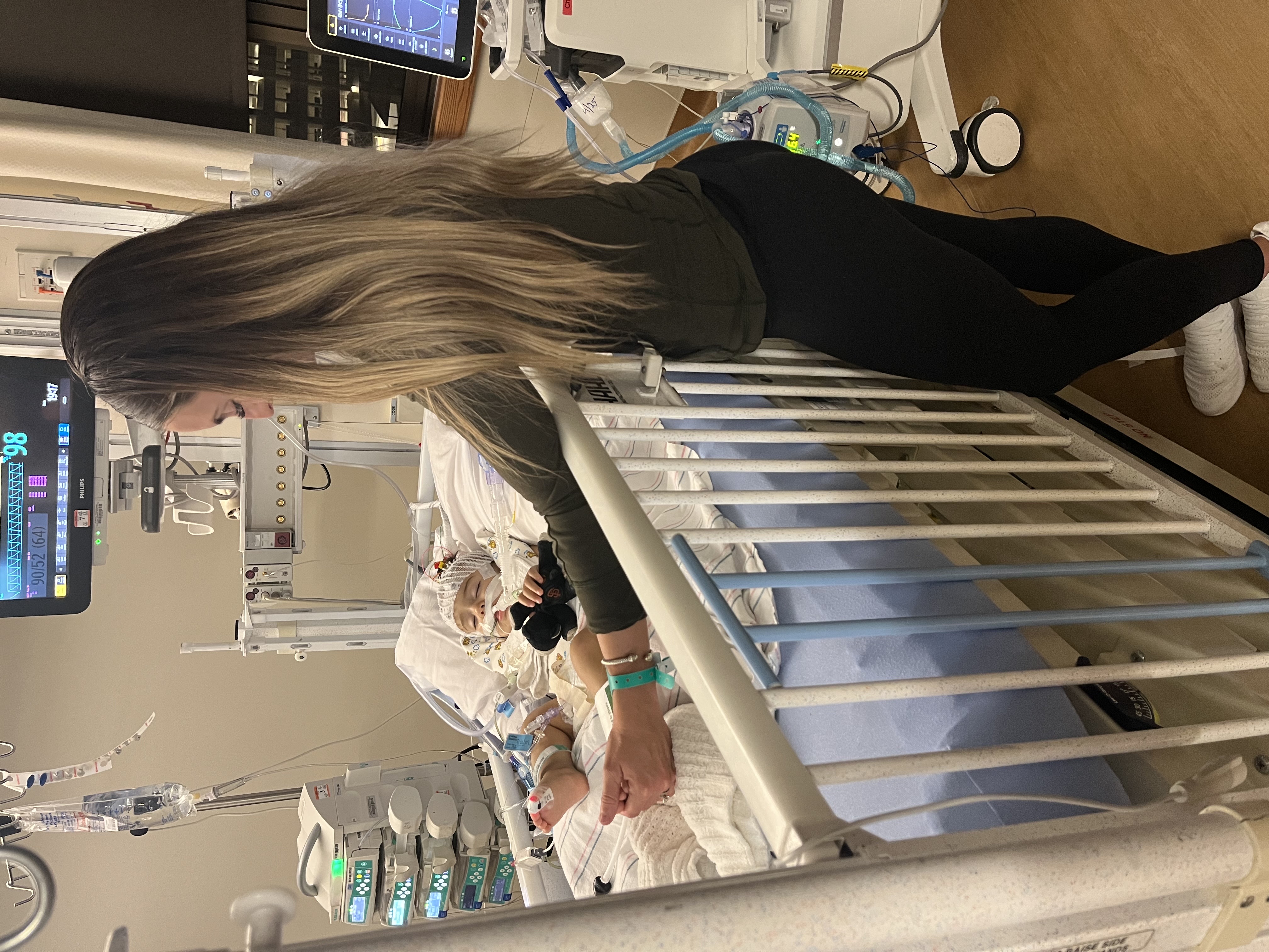 Women by bedside of son who is in critical condition