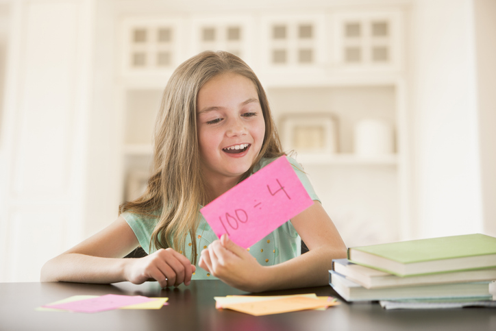 Little girl studying with flash cards