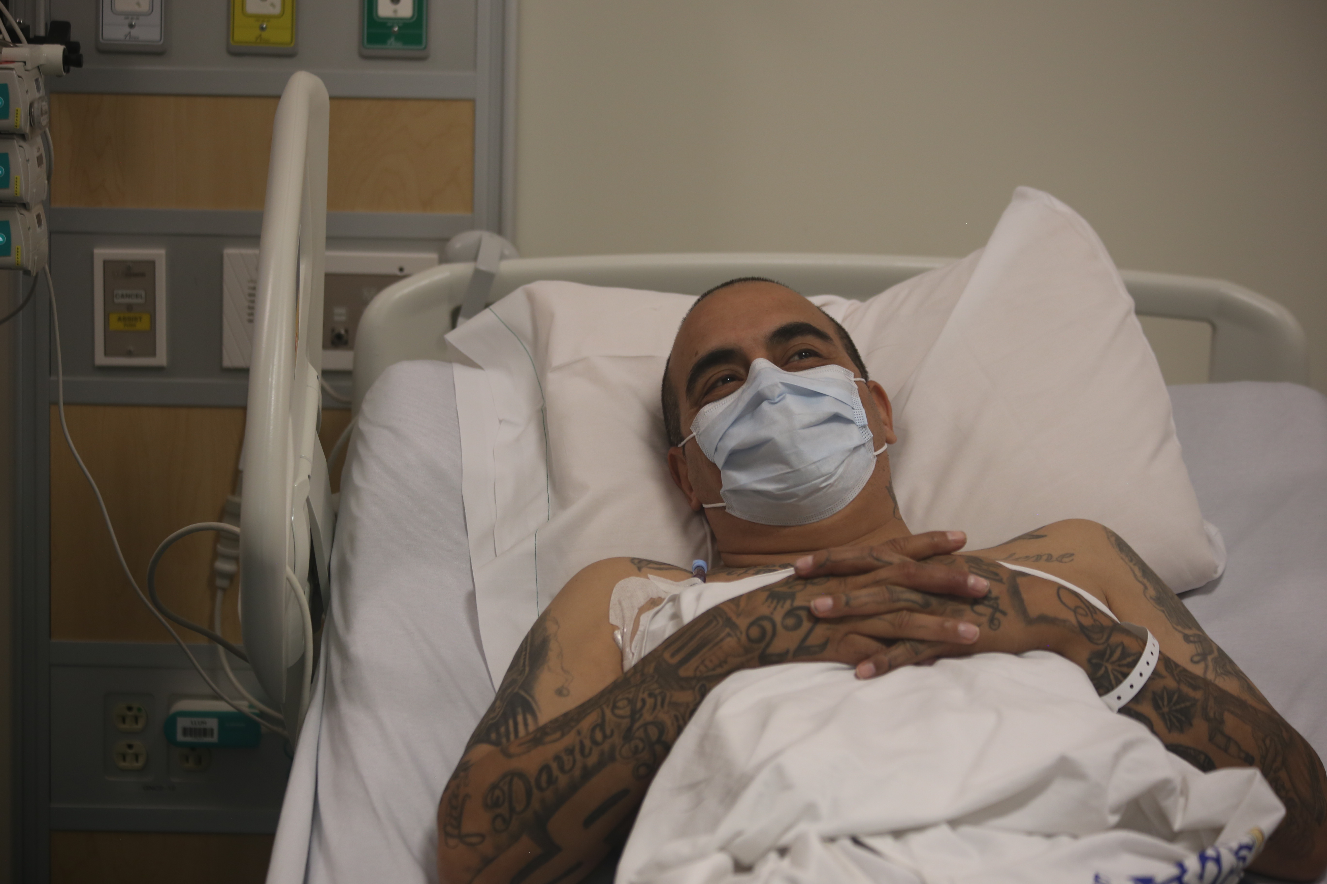 a man lays in a hospital bed