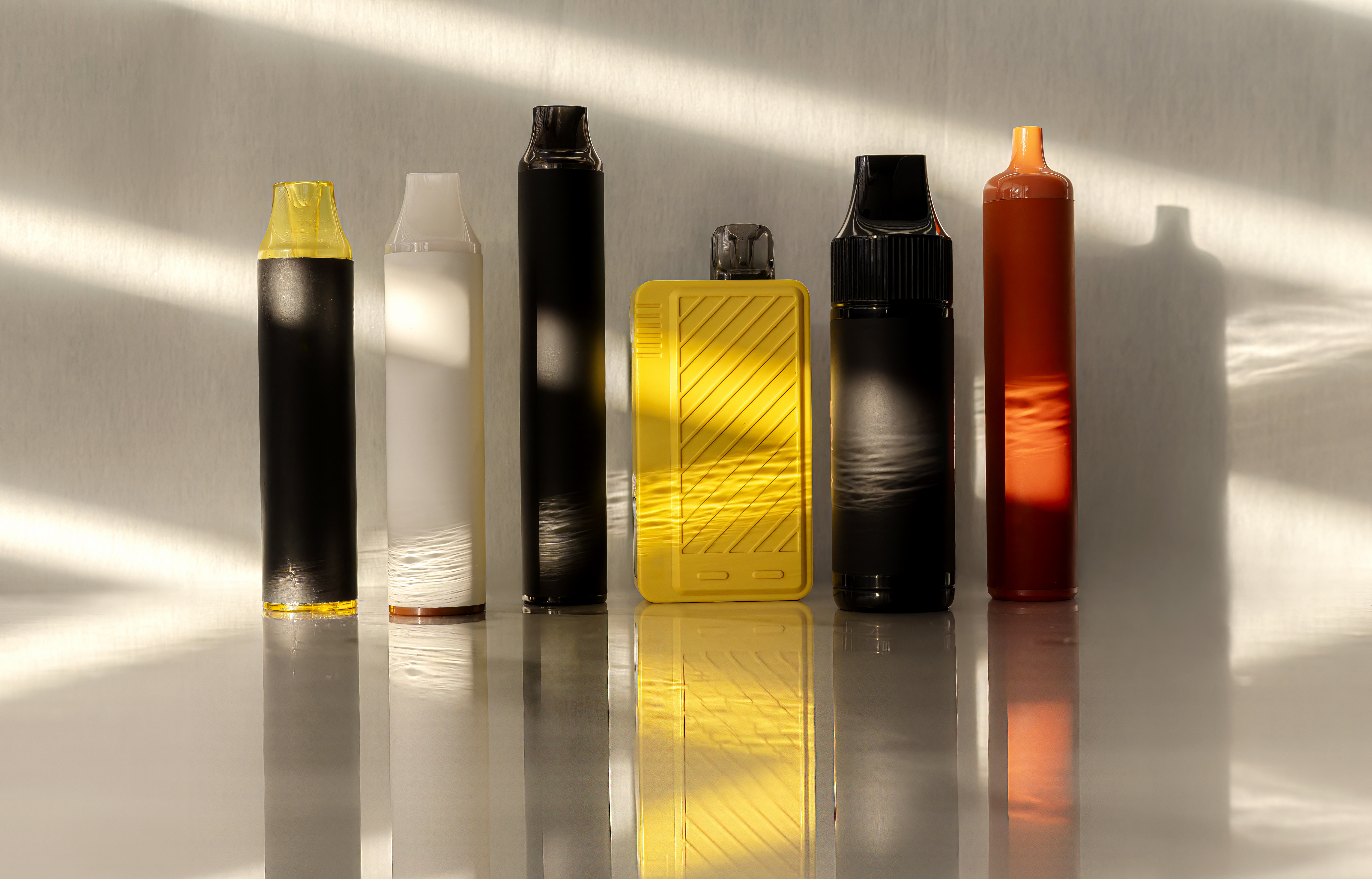 lectronic Cigarettes, Assortment of disposable e-cigarettes on a white background