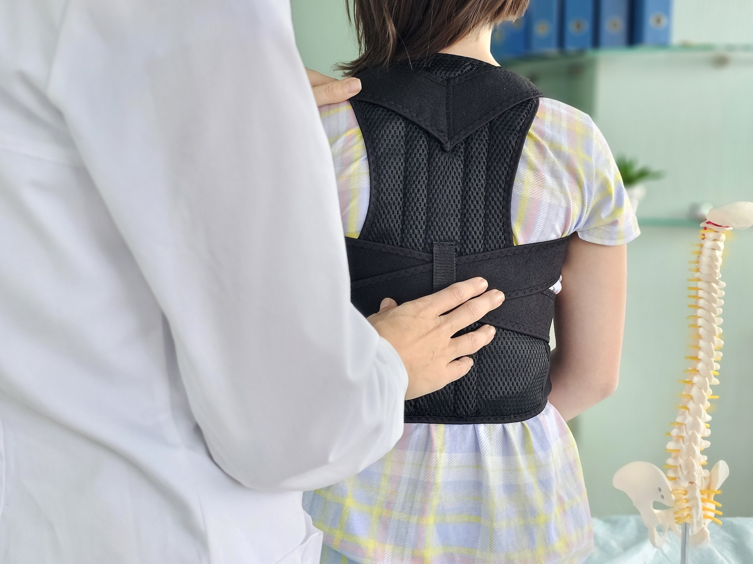  Posture correction device worn by a young individual in a clinical setting