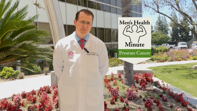 Prostate cancer is the second leading cause of cancer death in American men A doctor who wears a white coat stops with his hands behind the back while looking at the camera. He is in front of a medical building