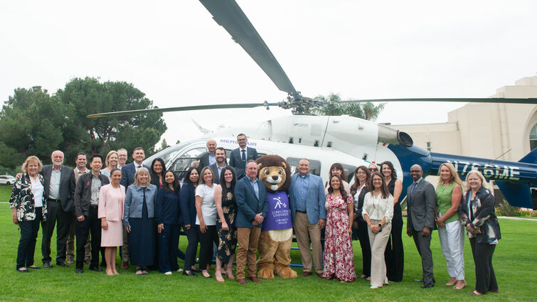 LLUH Administration and staff stand in front of new helicopter