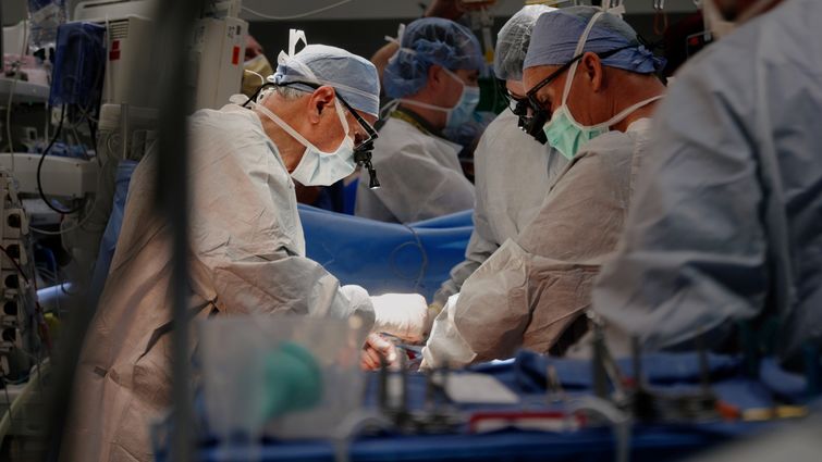 Three doctors operating on 12-year-old patient