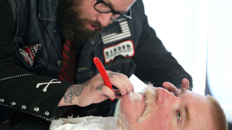 Barbers from Boom Botz Gentlemen’s Parlor offered free shaves to gentlemen who skipped shaving for a month at the conclusion event for No Shave November. SBPD detective Von Verbanic looked fresh and clean after his straight blade shave. No Shave November