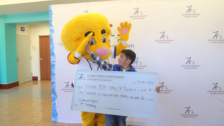 Ulysses Hsu, 9 got a well-deserved high-five form LLUCH mascot Luke the Lion Monday march 6 after he donated his birthday money to the hospital to support Vision 2020. Ulysses Hsu high fives the Children’s Hospital mascot, Luke the Lion