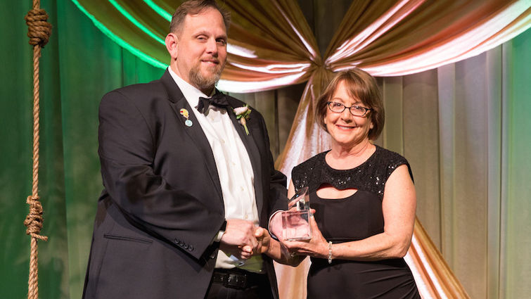 Scott Perryman (left), vice president/administrator, LLUCH, presents Alane Allbee, RN, with the Hometown Hero Award at the 24th annual Foundation Storybook Gala on Thursday, Feb. 16.