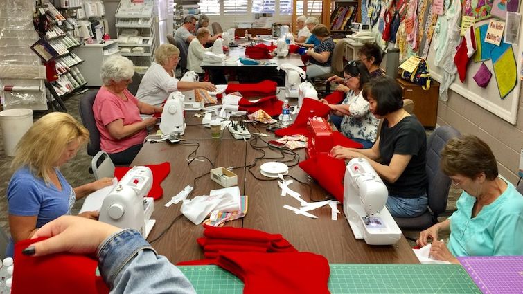 Volunteers work diligently at Redlands Sewing Center on June 10 to create 200 stockings for the Total Care Birth Center at LLUCH.