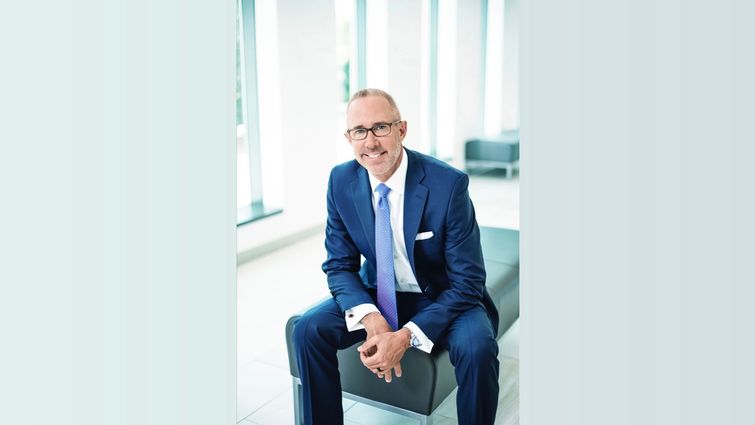 Caucasian man in business suit sitting in a hospital lobby