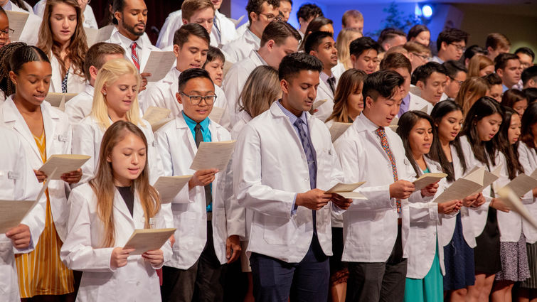 first-year medical students stand on the church steps to recite oath