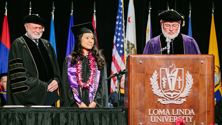 Marissa Lee listens as Ronald L. Carter, PhD, provost of Loma Linda University, details her accomplishments as winner of the 2018 President’s Award for the Loma Linda University School of Public Health. To her left is President Richard H. Hart, MD, DrPH.
