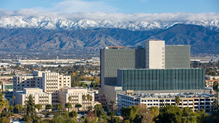 scenic view of hospital and snow-capped mountains in background