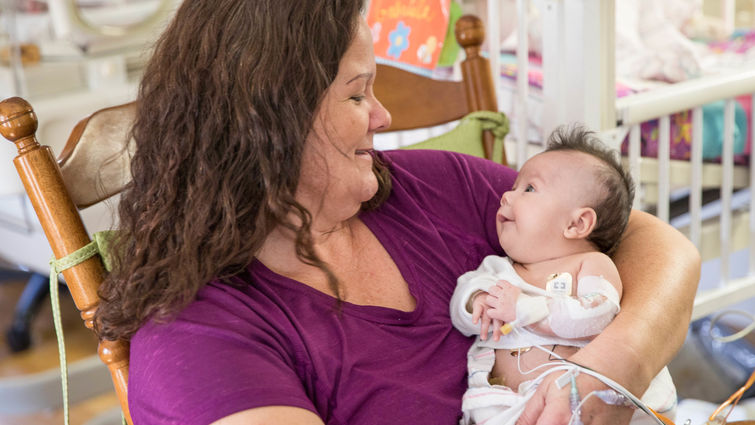 small baby in arms of her mom