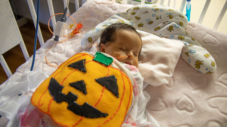 female infant with felt pumpkin costume