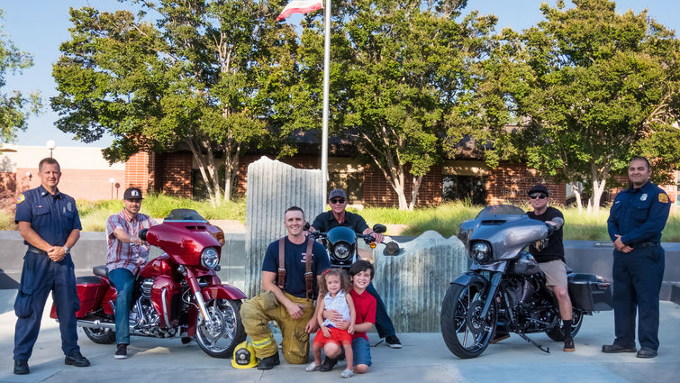 Two children who have received treatment at Loma Linda University Children’s Hospital (center) recently visited the 9/11 Memorial in front of the Loma Linda Fire Department. They're joined by future participants in the upcoming 9/11 Memorial Ride.