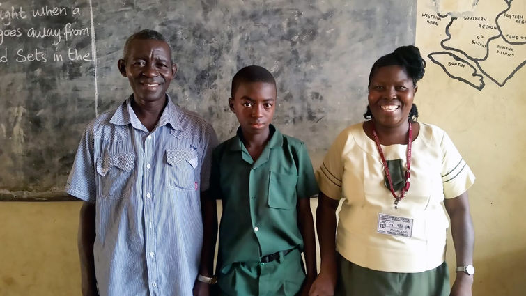 Citizens of Sierra Leone have been seriously traumatized by an 11-year civil war and the Ebola crisis. This man and boy pose with their teacher, one of 25 volunteers trained in anxiety and stress reduction by Loma Linda University researchers