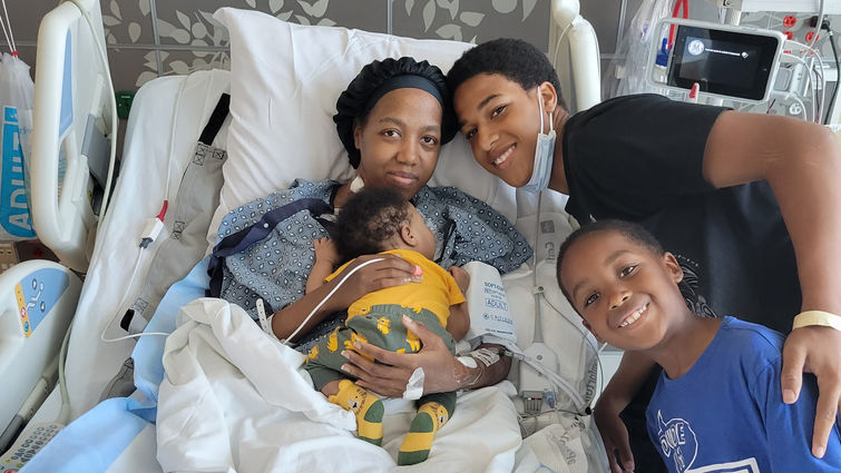 LaCresha Bell arrived at LLUMC for a higher level of care when she went into cardiogenic shock after having given birth to her second son. Bell's two sons and younger brother visited her during the three-month hospital stay. LaCresha Bell at Loma Linda University Medical Center, surrounded by family (her two sons and younger brother).