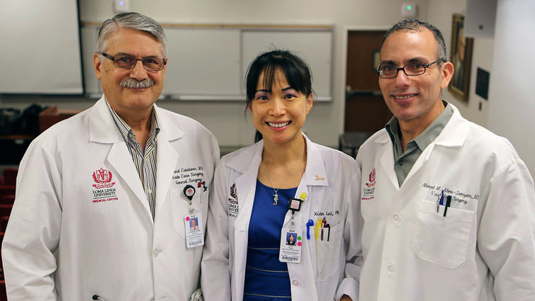 Richard Catalano, MD, Xian Luo, PhD, and Ahmed Abou-Zamzam, MD, celebrate the news that the National Trauma Institute recently received a $4.6 million Department of Defense grant to develop a National Trauma Research Repository Left to right: Dr. Richard Catalano, Dr. Xian Luo, and Dr. Ahmed Abou-Zamzam smile