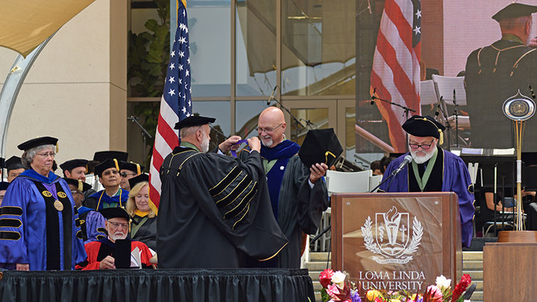 William "Billy" Hughes, PhD, immediate past dean of the LLU School of Pharmacy, receives the University Distinguished Service Award from Richard Hart, MD, DrPH, president of Loma Linda University Health. Commencement ceremony for Loma Linda University School of Pharmacy Class of 2016 Graduates