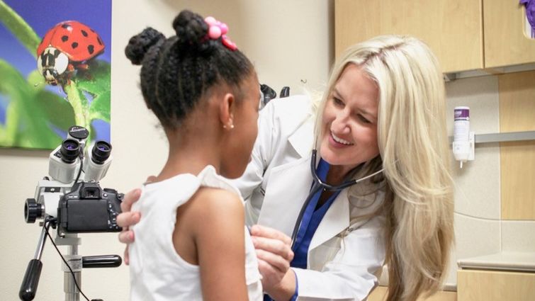 Dr. Young listens to patient's heart