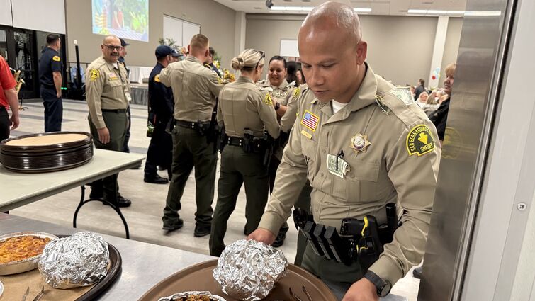 San Bernardino County Sheriff's deputies volunteered as waitstaff, collecting tips that were donated back to LLUCH Sheriif's deputy serving food at event