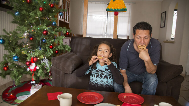 Father and daughter, taking Christmas snack 