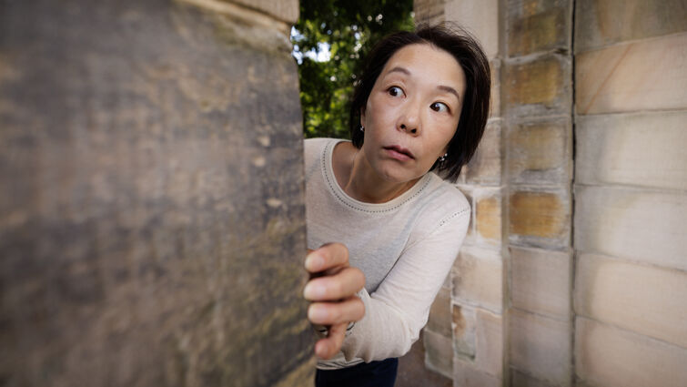 Woman peeking around corner