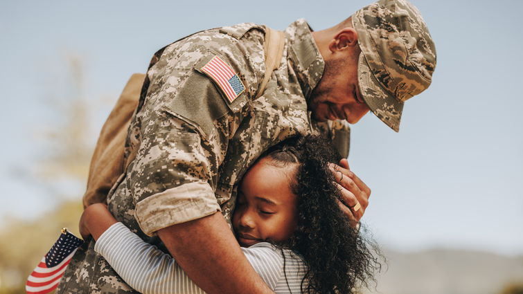 Emotional soldier hugging his daughter - stock photo