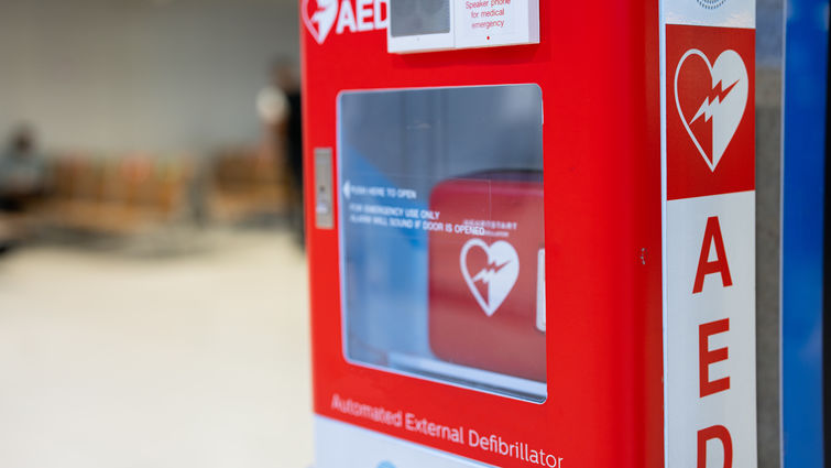 An Automated External Defibrillator, (AED) placed on the wall in public locations.