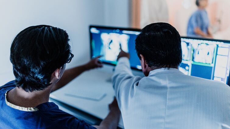 Doctors analyzing tomography medical x-ray at hospital