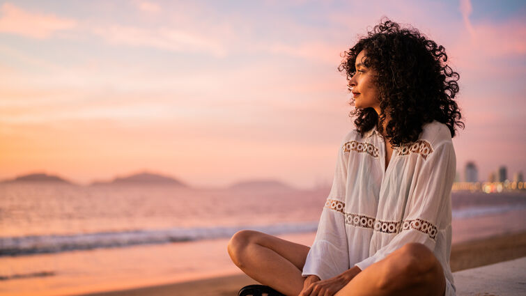 Woman staring out into the ocean. 