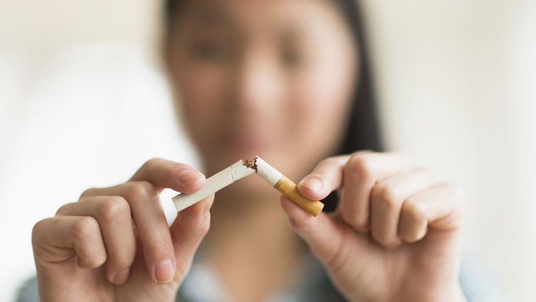 Girl breaking a cigarette