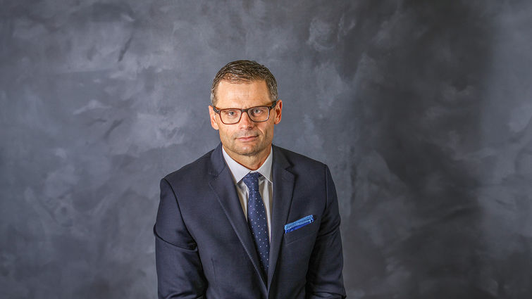 Caucasian man business headshot in suit and tie wearing glasses