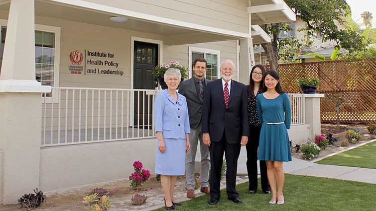 Members of the Institute for Health Policy and Leadership stand in front of the office