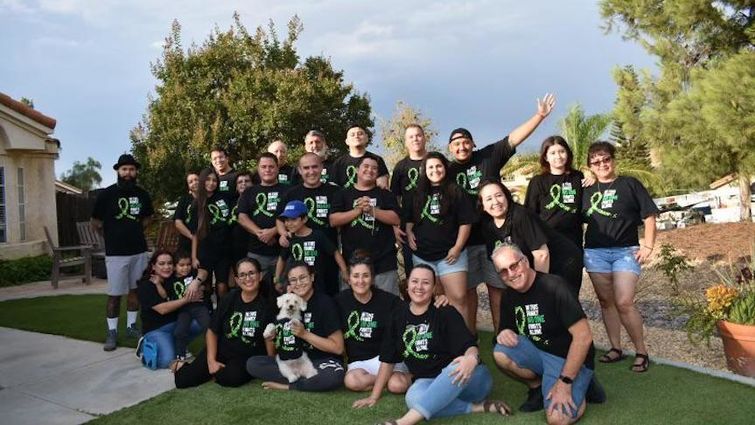 Coyt family and friends sport matching shirts that say, "In this family no one fights alone." Coyt family photo - everyone wearing shirt that says "In this family no one fights alone"