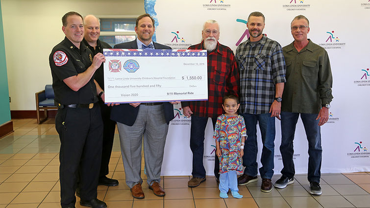 Monies raised by the Loma Linda and Colton fire departments and Quaid Harley-Davidson will benefit patients of Loma Linda University Children's Hospital like the boy in the foreground.