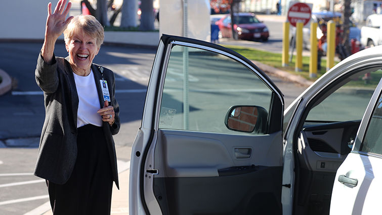 Mary Clement's smile reflects her exuberance over the Department of Public Affairs' new van.