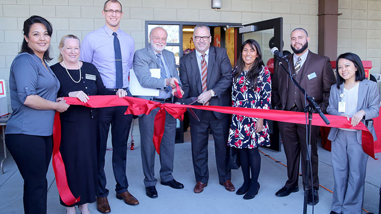 Officials of Loma Linda University Health and political and community leaders getting ready to cut the ribbon at the grand opening for Digital Production Ink.