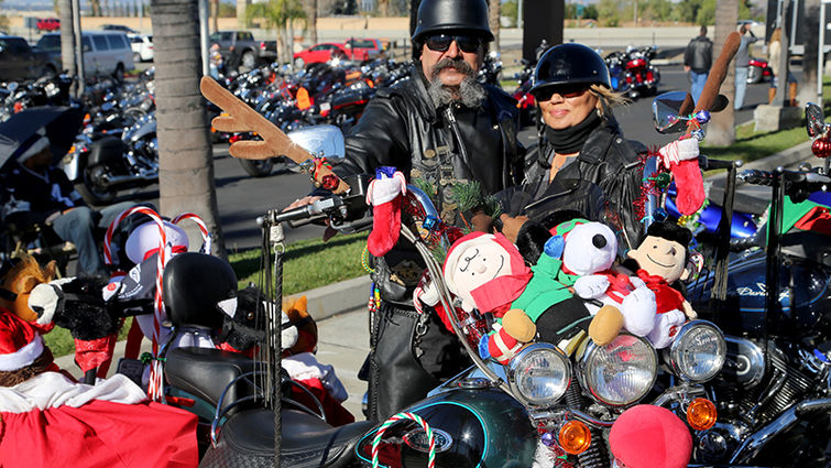 Bikers go all out to share the love with children at Christmas. This couple won the prize for best decorated bike at the 24th annual Quaid Harley-Davidson Toy Run.