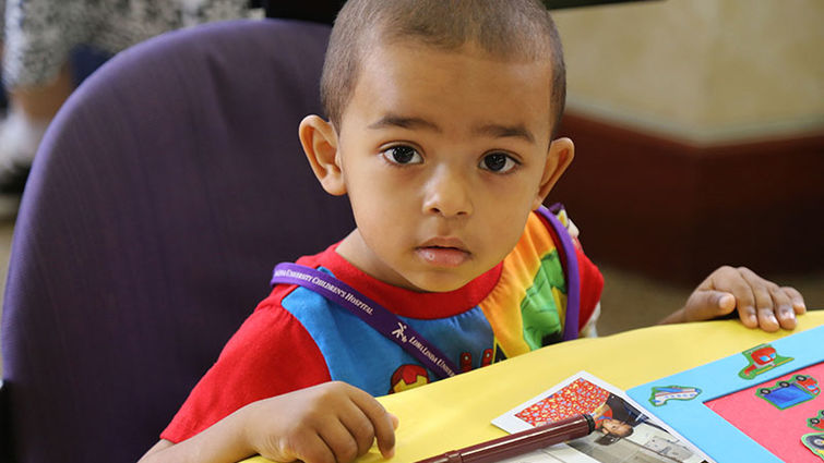 A patient at Loma Linda University Children's Hospital enjoys time for play during the annual Fall into Reading event